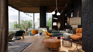 A modern living room with a fireplace, large windows, and a variety of seating options. - Hotel Euro (Pardubice)