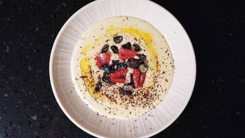 A white plate with a dessert on a dark countertop.