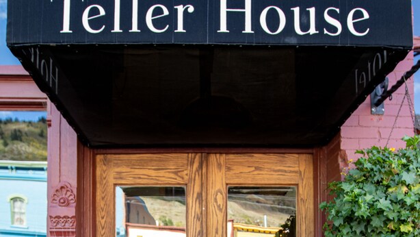A wooden door with a sign above reading "Teller House." - Teller House (Silverton)
