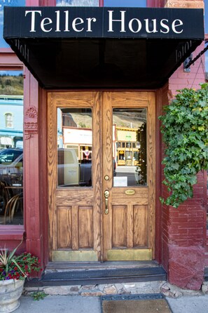 A wooden door with a sign above reading "Teller House." - Teller House (Silverton)
