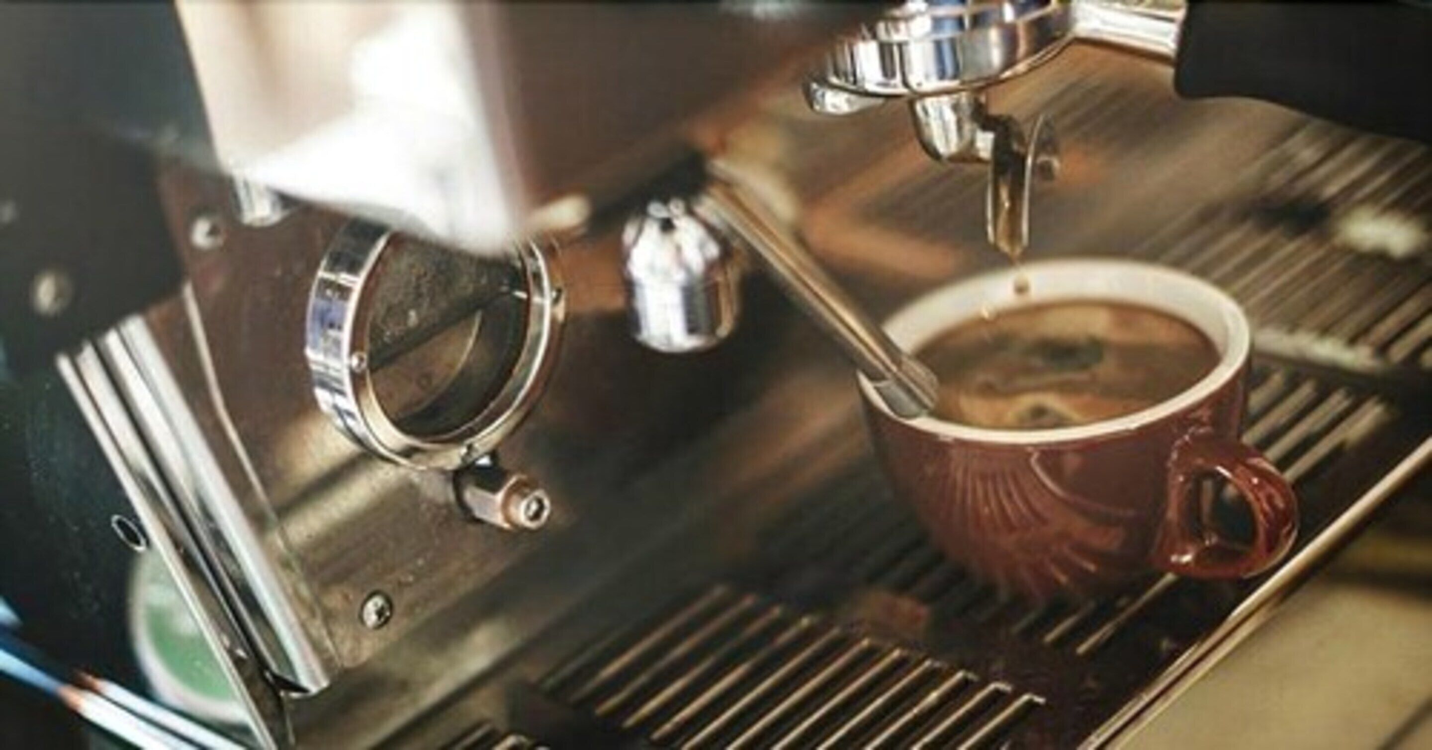 A coffee machine dispensing coffee into a cup.