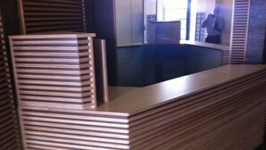 A reception desk with a wooden finish and a mirror above it. - City Center Jerusalem (Jerusalem)