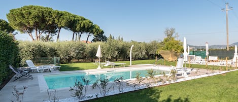 Seasonal outdoor pool, open 9:00 AM to 8:30 PM, pool umbrellas