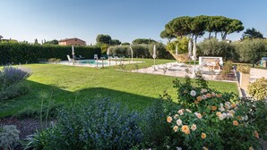 A well-maintained garden with a swimming pool, lounge chairs, and a pergola. - Rosa di Assisi (Bastia Umbra)