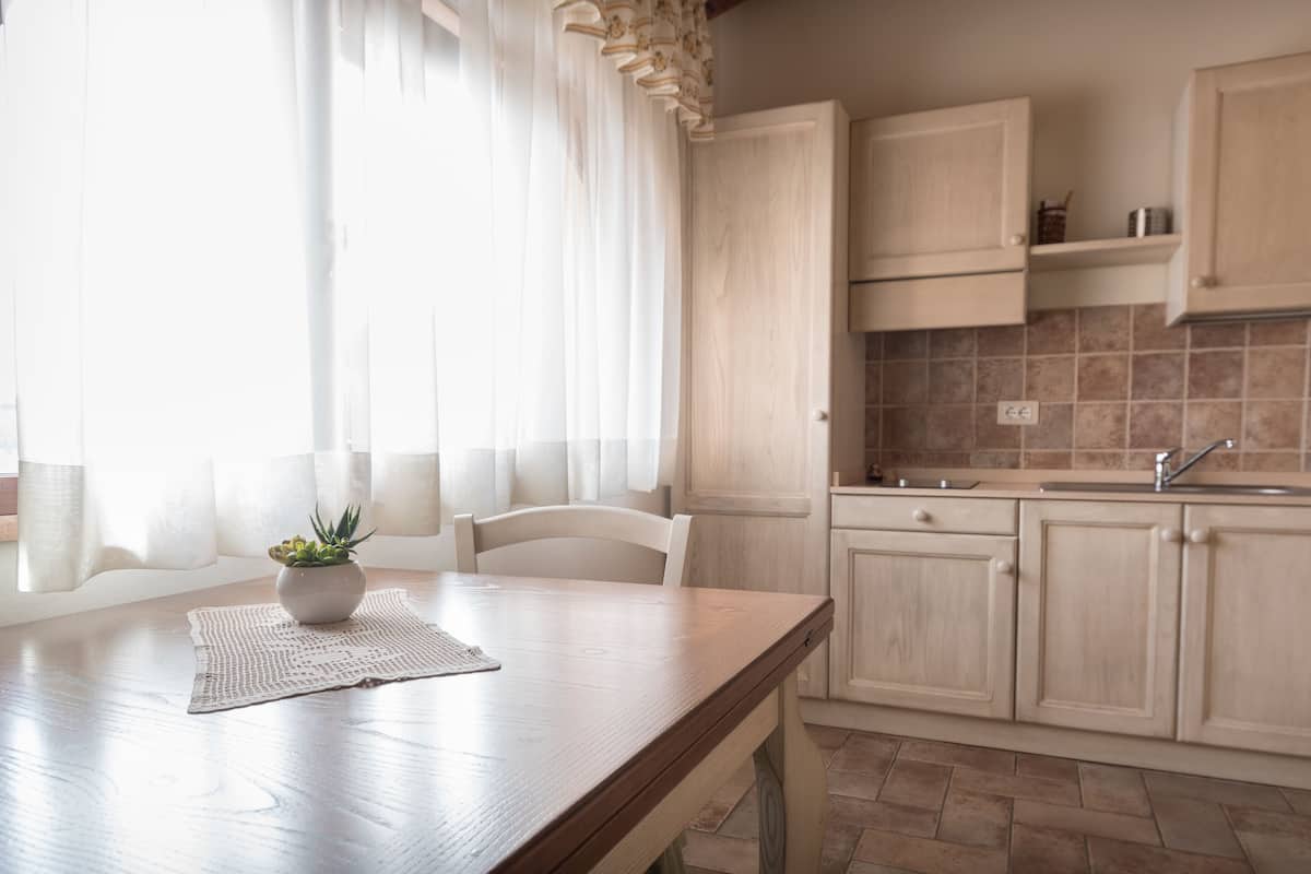 A kitchen with wooden cabinets, a countertop, and a sink.