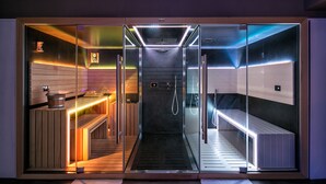 A modern, glass-walled sauna with a wooden bench and a control panel. - UmbriaVerde Sporting & Resort (Massa Martana)