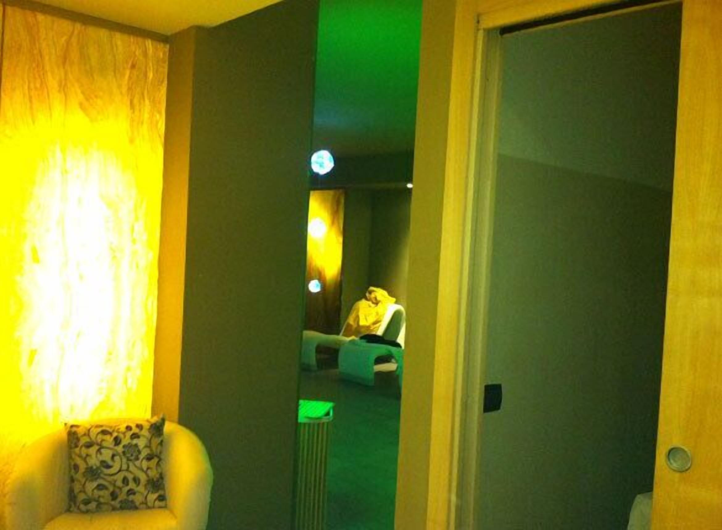 A room with a bed, a chair, and a radiator.