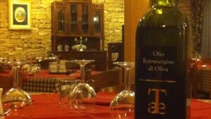A bottle of Olio Extraverine di Oliva on a table in a restaurant setting. - UmbriaVerde Sporting & Resort (Massa Martana)