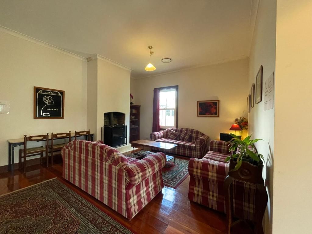 A living room with a sofa set, a coffee table, a TV, and a fireplace.