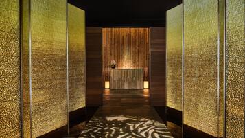 Enter a reception area with a unique textured wall pattern and a beautifully tiled floor.