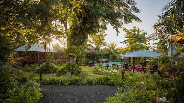 A lush garden with a gazebo, a pool, and outdoor seating. - The Samoan Outrigger Hotel (Apia)