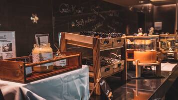 A buffet area with various food items and condiments displayed on wooden stands.