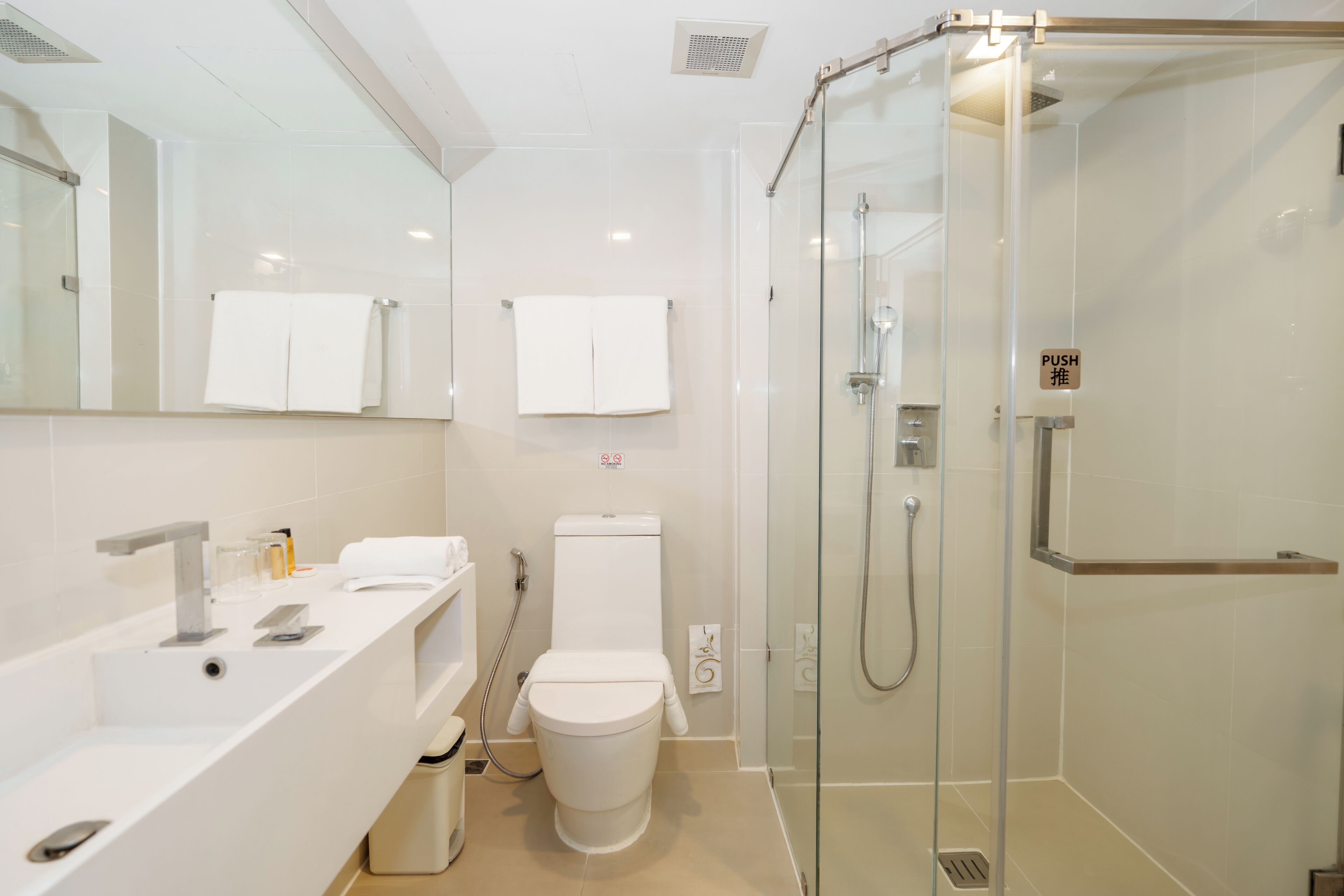 deluxe twin room | bathroom | shower, rainfall showerhead, hair dryer, bidet