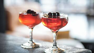 Two cocktail glasses on a textured surface.