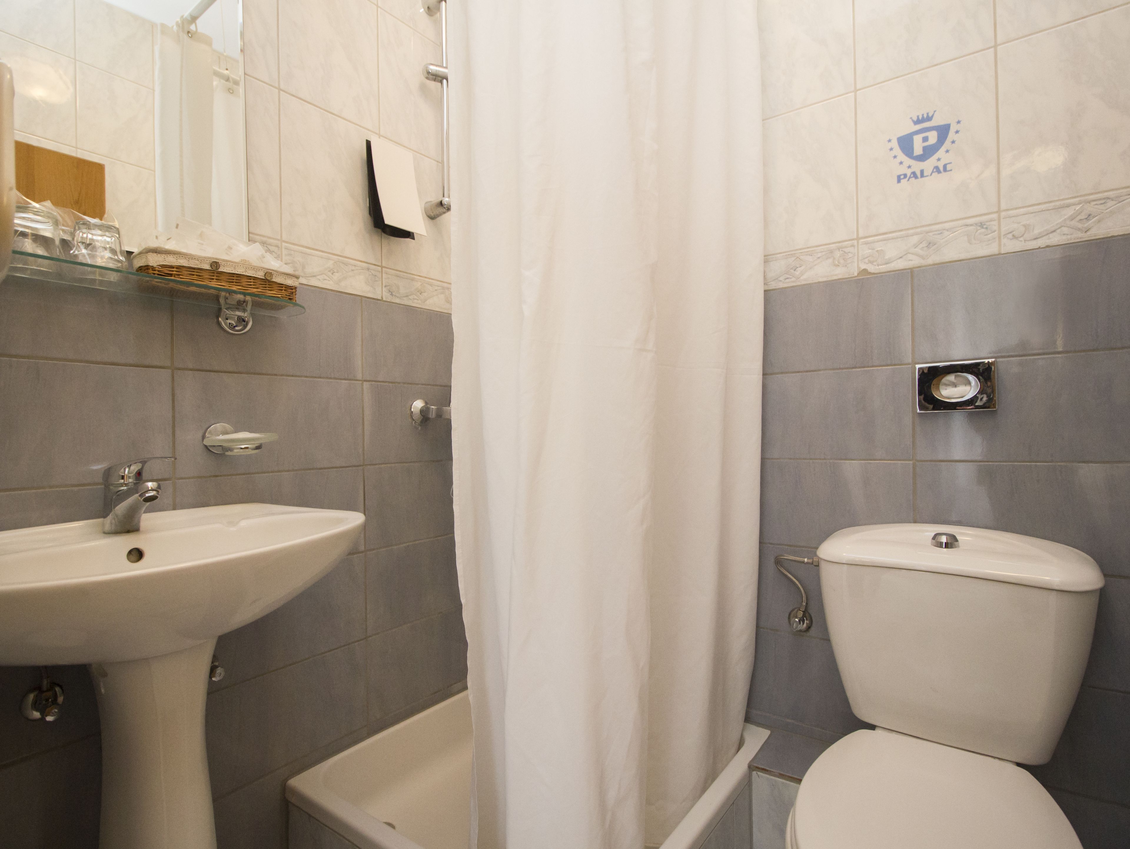 A bathroom with a sink, toilet, and bathtub.