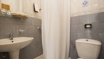 A bathroom with a sink, toilet, and bathtub.