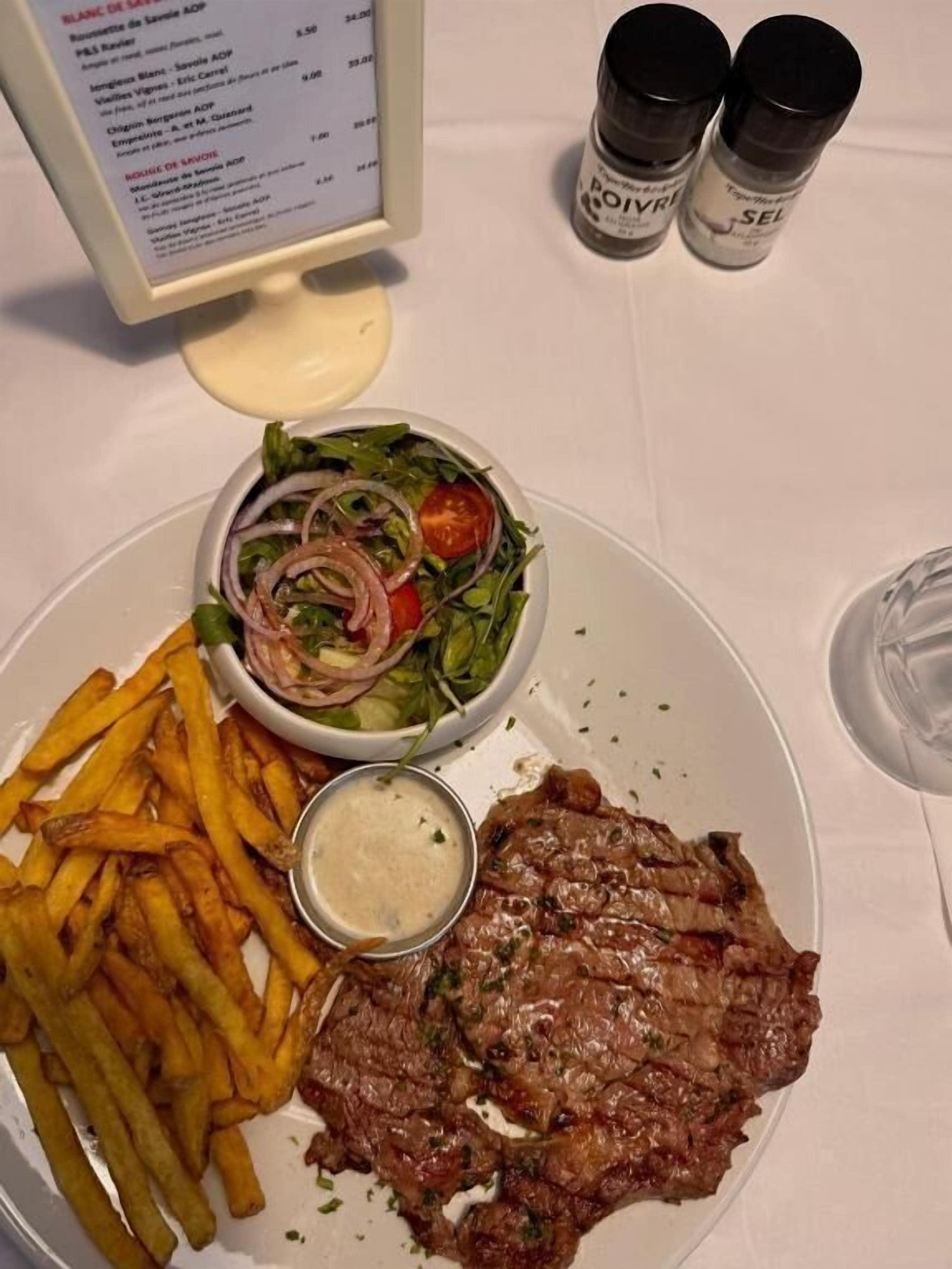 A plate with steak, fries, and a salad.