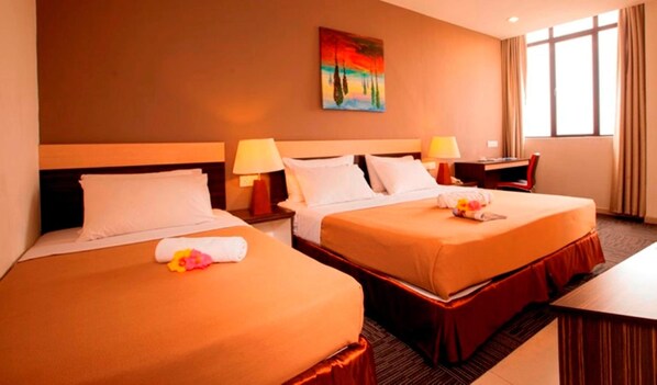 A hotel room with two beds, a desk, a chair, and a painting on the wall. - Leo Express Hotel (Kuala Lumpur)