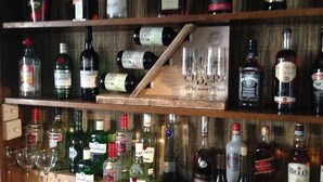 A bar area with shelves of liquor bottles and glasses. - Mildmay Arms (Yeovil)
