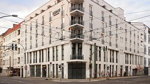 A modern building with multiple floors, balconies, and a prominent sign. - Numa Berlin Boxer (Berlin)