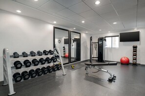 A gym with weightlifting equipment, a bench, and exercise balls. - Home2 Suites by Hilton Biloxi North/D'Iberville (D'Iberville)