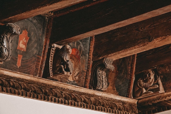 A wooden ceiling with intricate carvings and a decorative panel. - Schloss Mittersill Hotel (Mittersill)