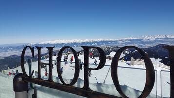 A snow-covered mountain with a clear sky.