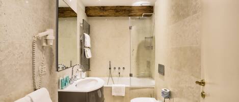 A modern bathroom with a vanity, sink, and shower.