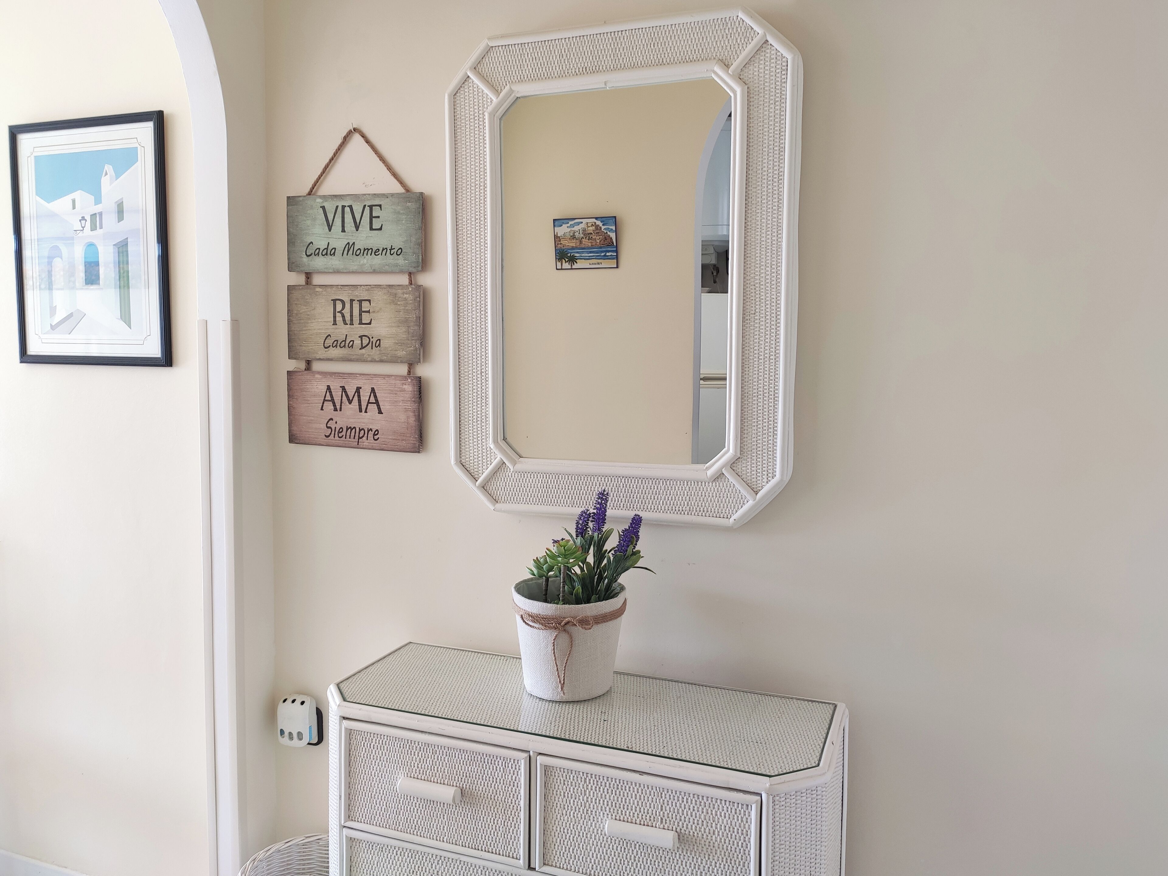 A bathroom with a white vanity, a mirror, and three wooden signs with motivational phrases.