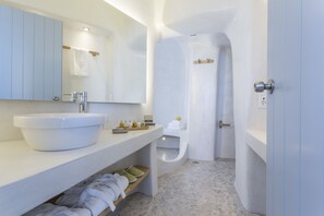 Junior Villa (Outdoor Heated Jetted Tub, Caldera View) | Bathroom | Shower, designer toiletries, hair dryer, slippers - Galini Hotel (Santorini)