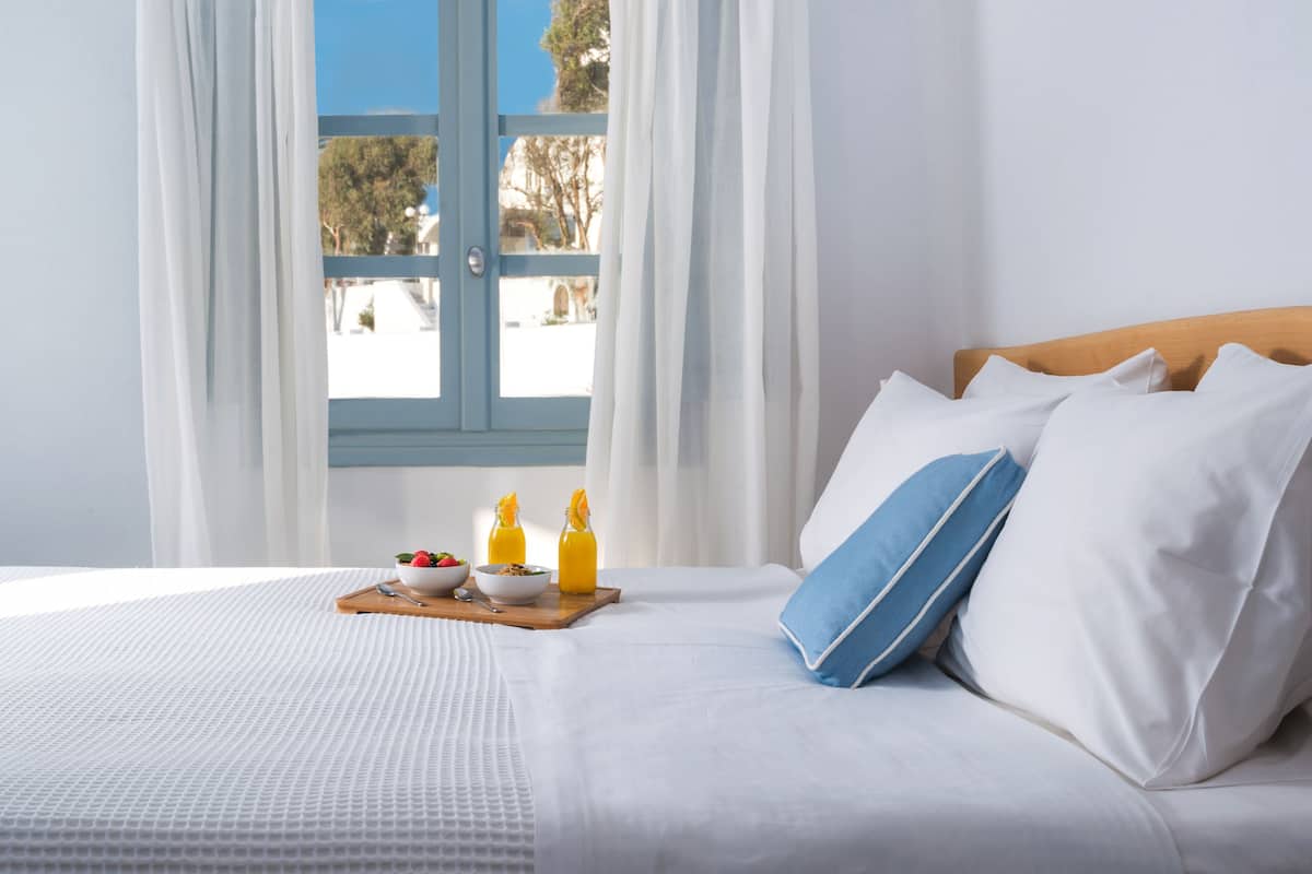 deluxe room (caldera view) | premium bedding, in-room safe, blackout curtains, iron/ironing board