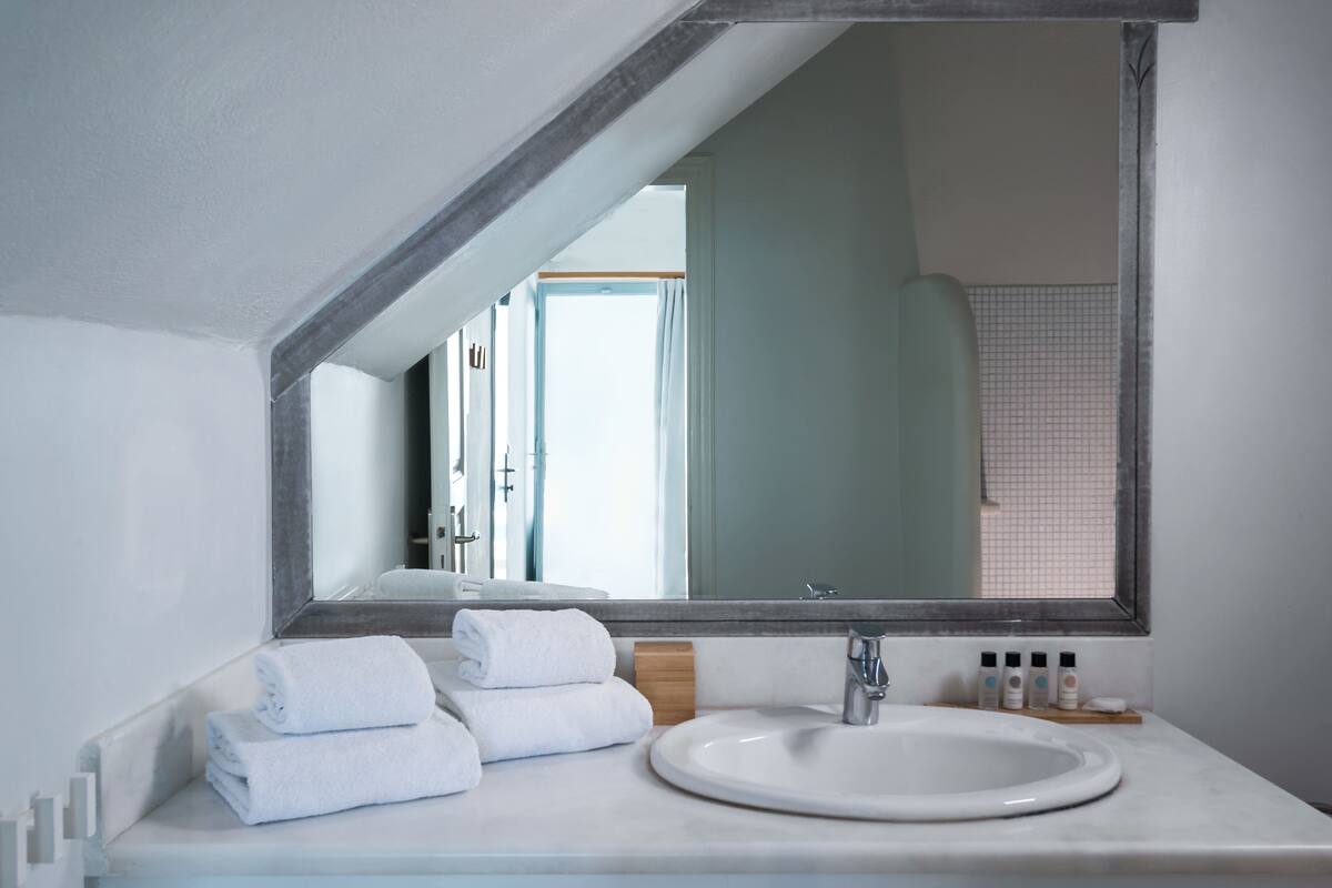 premier room (caldera view) | bathroom | shower, designer toiletries, hair dryer, slippers