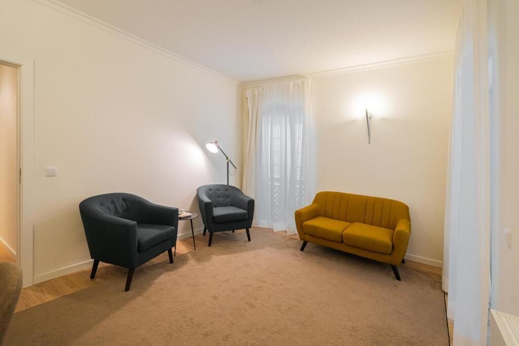 Suite, Balcony | Living area | 32-inch LCD TV with cable channels, books