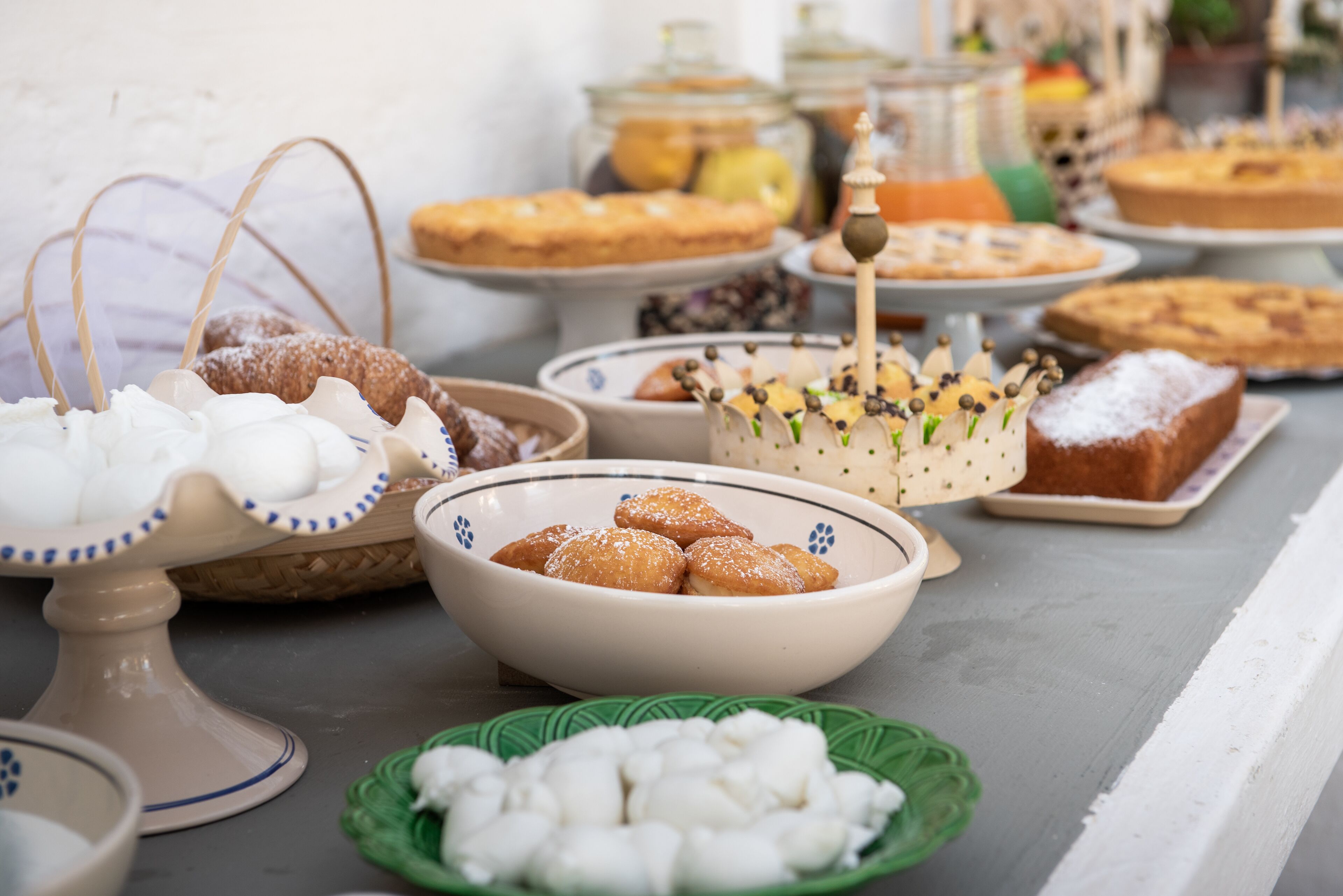 A buffet table with various desserts and pastries.