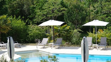 Seasonal outdoor pool, open 10:00 AM to 8:00 PM, pool umbrellas