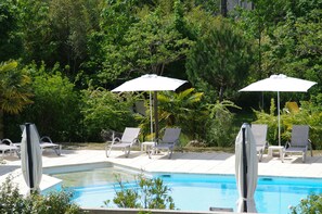 Seasonal outdoor pool, open 10:00 AM to 8:00 PM, pool umbrellas