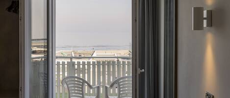 Triple Room, Sea View | Minibar, in-room safe, desk, free WiFi
