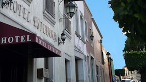 A hotel with multiple signs reading "HOTEL" and "HOTEL ESTEFANIA" on the facade. - Hotel Estefania (Morelia)