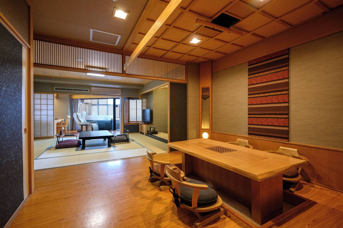 A traditional Japanese-style room with tatami flooring, a low wooden table, and shoji screens.
