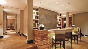 Relax in our spacious lobby, featuring a unique reception desk and comfortable seating area.