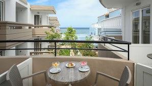 A balcony with a table set for two, overlooking a coastal view. - Mare Boutique - Adults Only (Apokoronas)