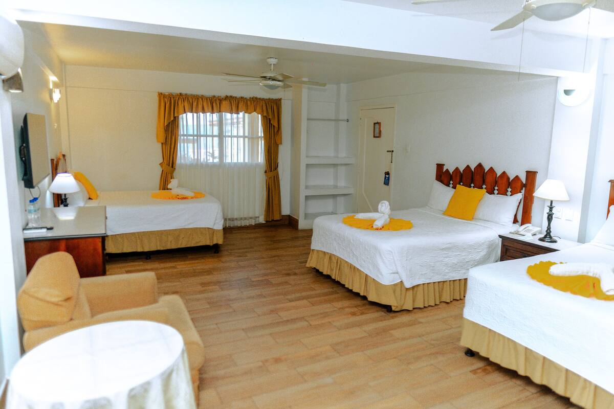 Habitación triple Premium, varias camas | Cortinas opacas, wifi gratis, ropa de cama