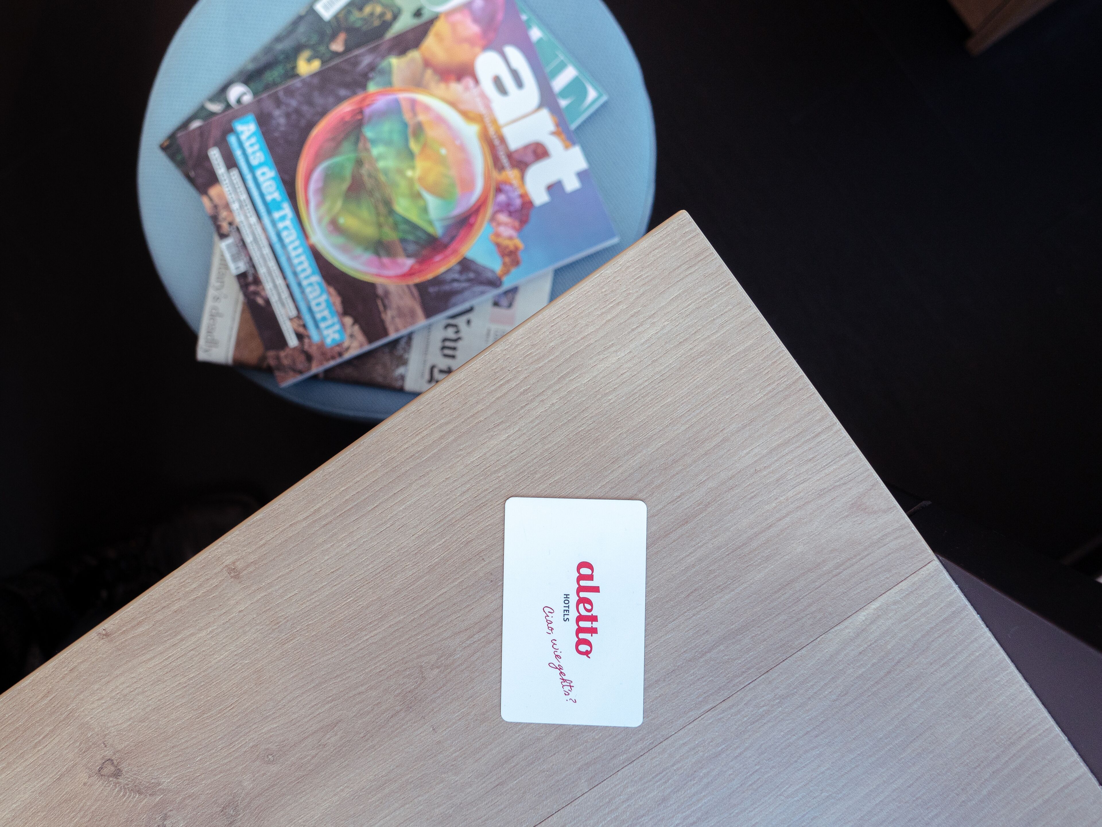 A wooden surface with a white card labeled "aletto hotels."