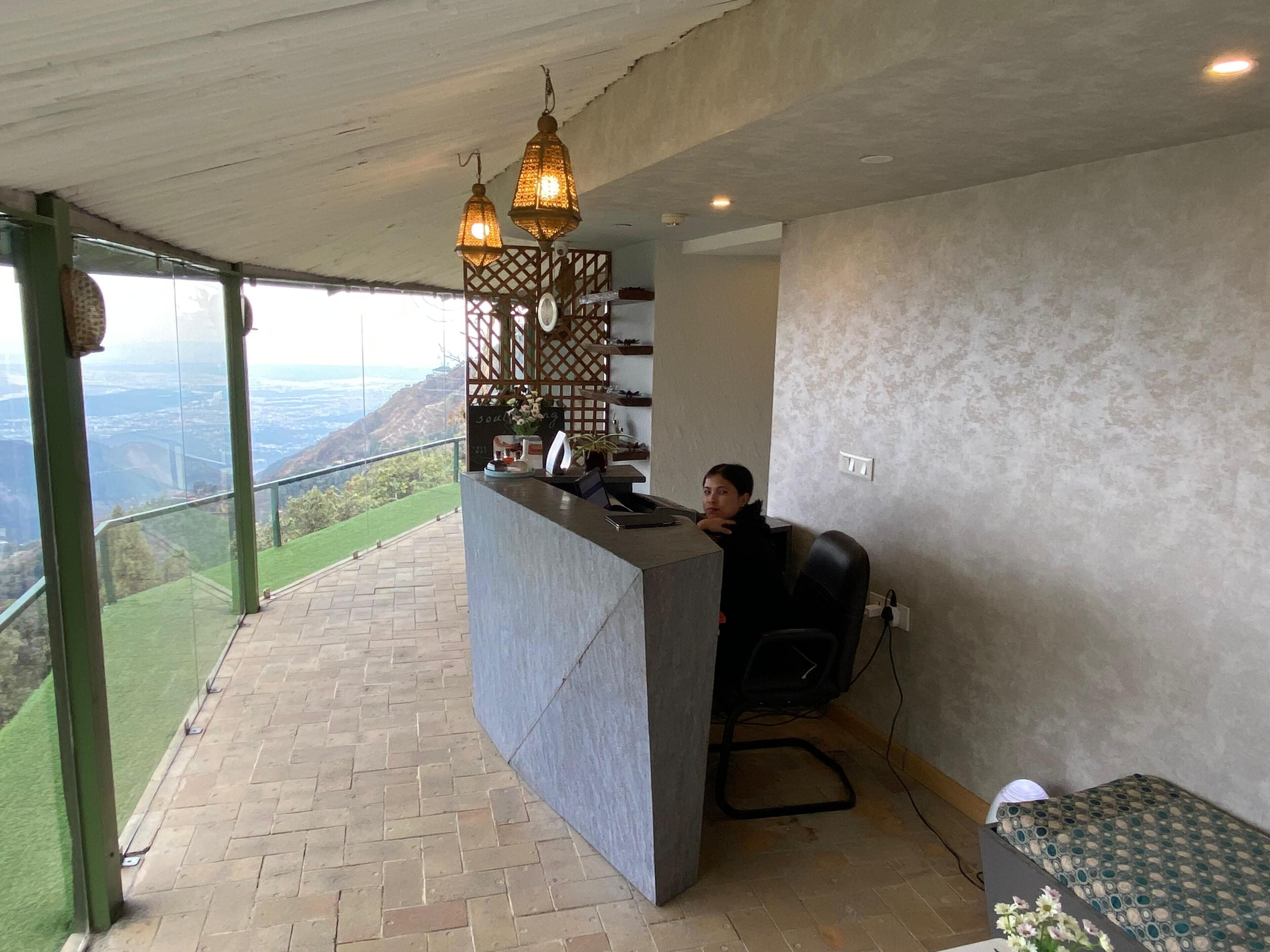 A reception desk with a view of a mountainous landscape.