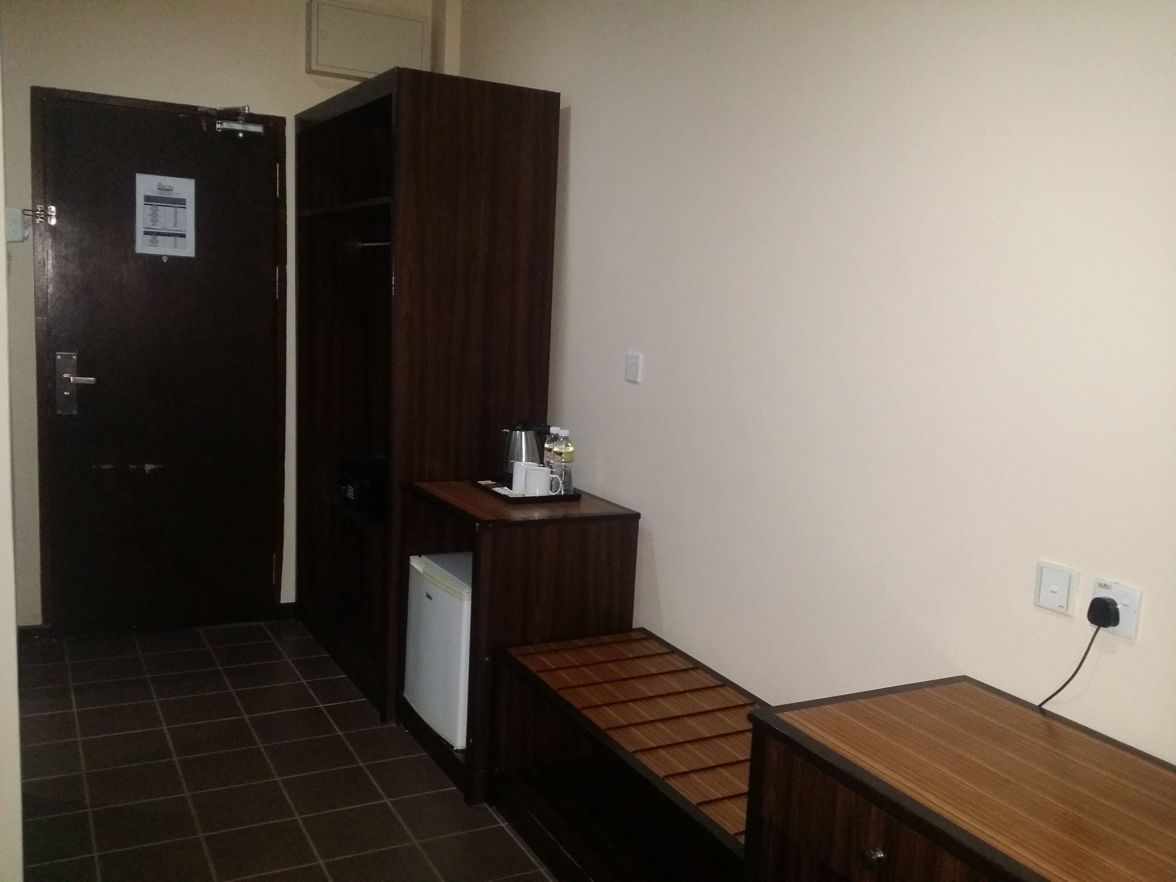 A small kitchenette with a refrigerator, a coffee maker, and a microwave.