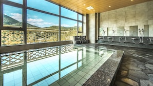 A large indoor swimming pool with a view of a mountainous landscape through large windows. - Ryokan Nenrinbo (Kyoto)