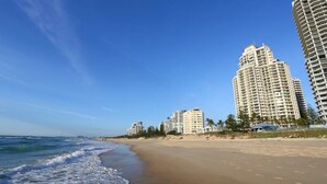 A beach with high-rise buildings in the background.