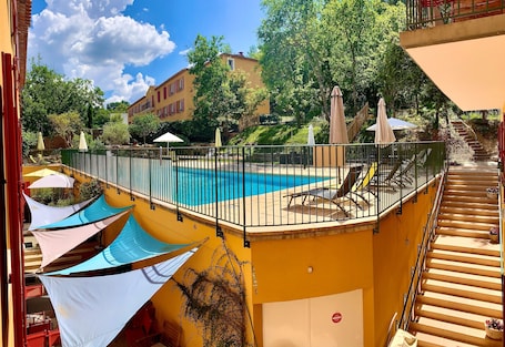 Seasonal outdoor pool, open 9:00 AM to 9:00 PM, pool umbrellas