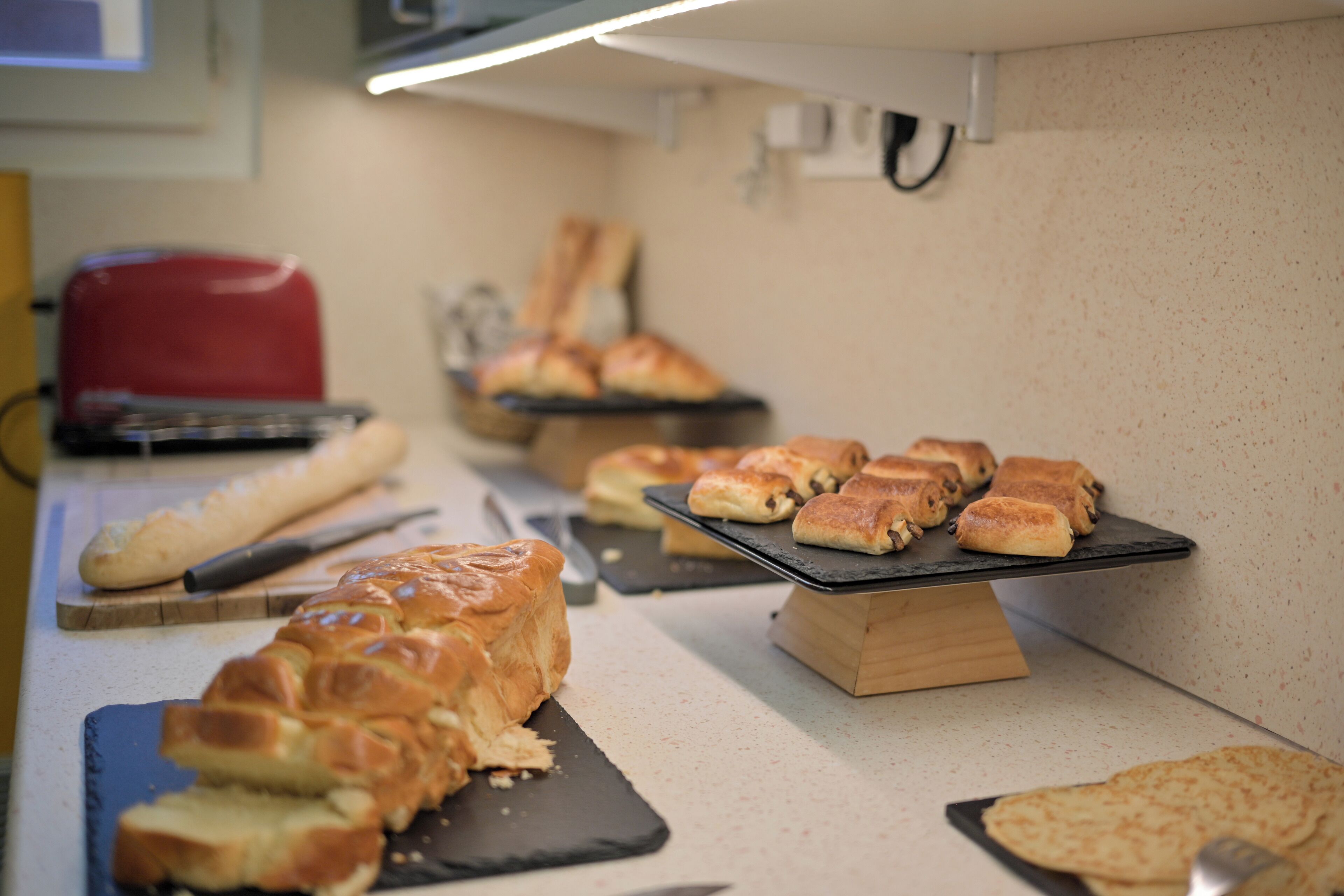 A bakery display with various breads and pastries.