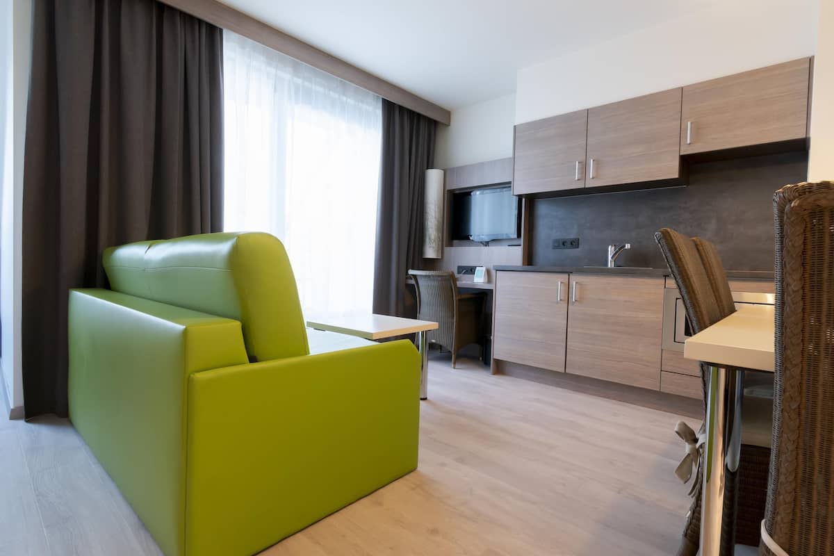 junior suite, 1 king bed with sofa bed, balcony | in-room safe, desk, laptop workspace, blackout curtains